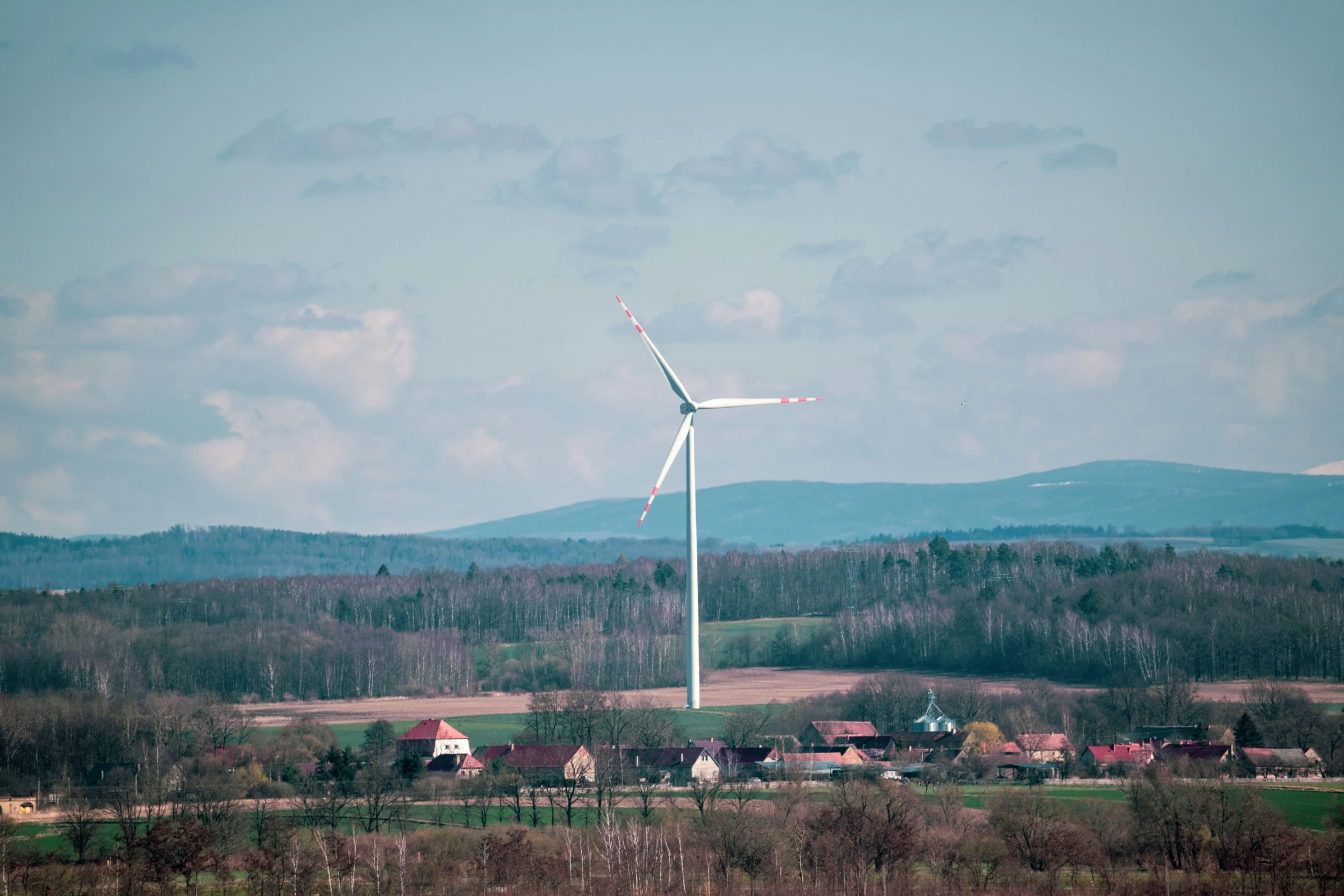 a windmill on top of a hill in the middle of the day