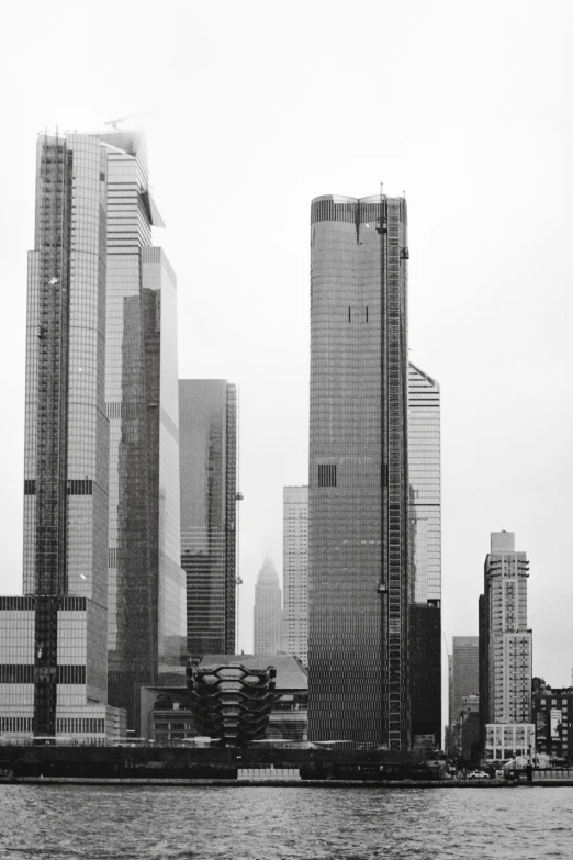 a black and white po of a city with tall buildings on either side