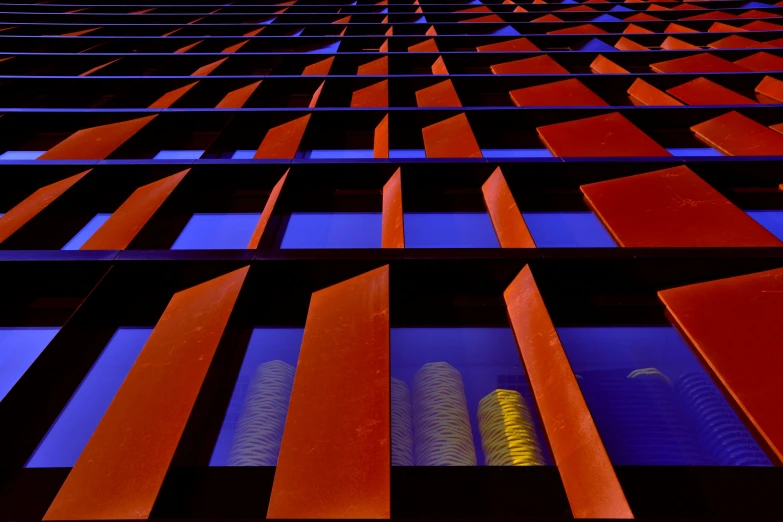 the image is bright orange and blue against the building