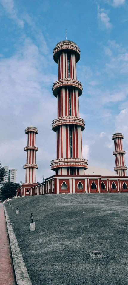 large brick building with red and white stripes on top