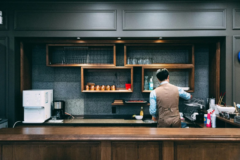 a man standing at a bar making drinks