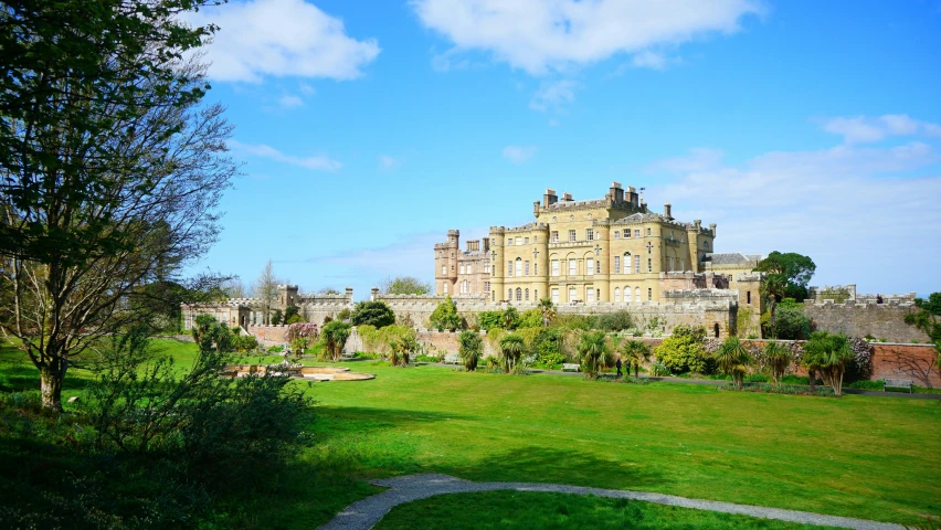 an old building surrounded by a lush green field