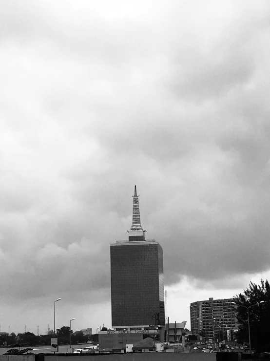 a black and white po of a city with a sky background