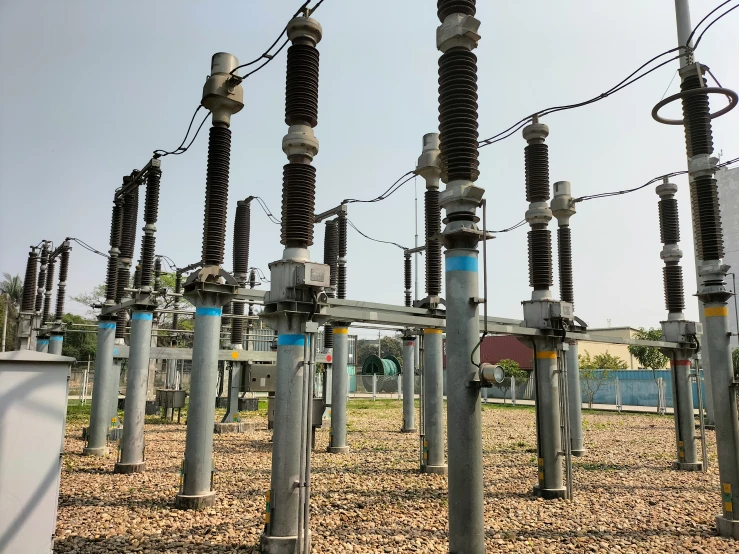 a row of high voltage lines in an open field