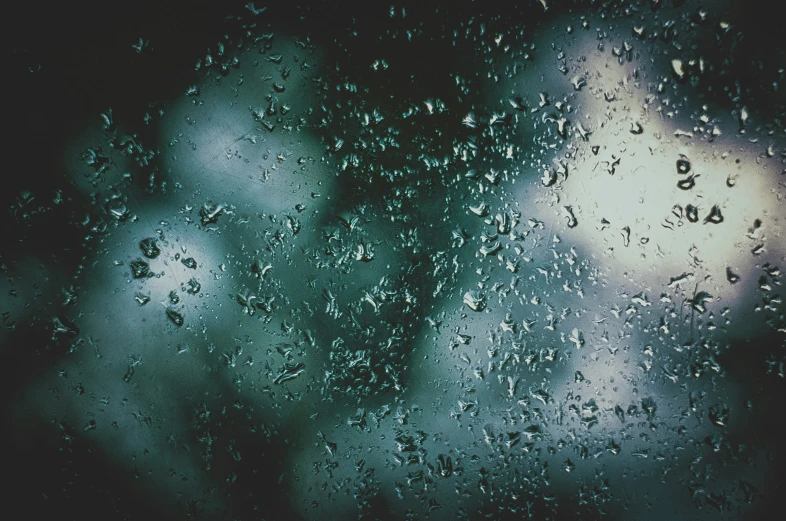 rain droplets are seen on the window with the word safe