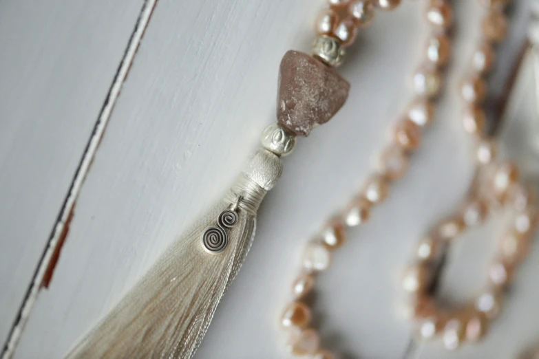 a beaded necklace sitting on top of a white box