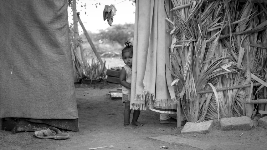 a girl that is sitting under a cover