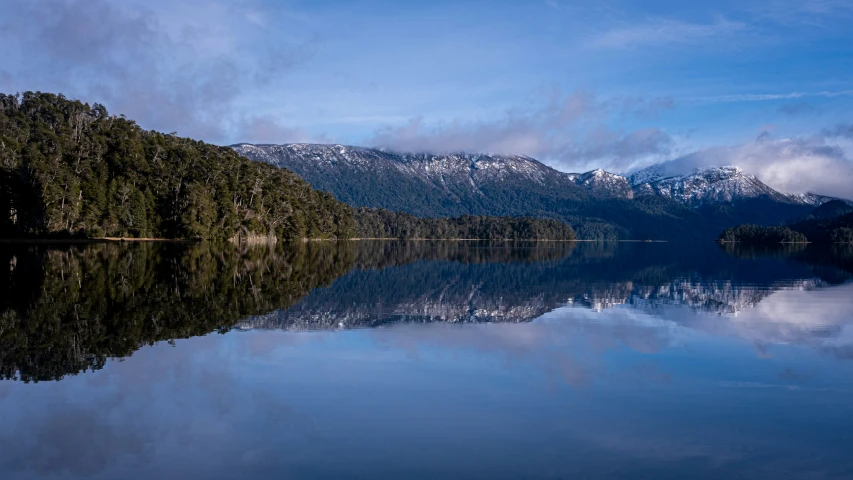 a body of water surrounded by mountains and trees