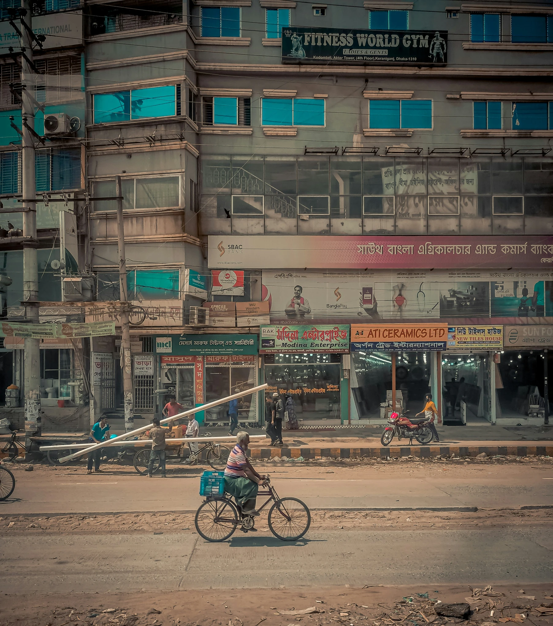 a man rides a bicycle past an office building in the city