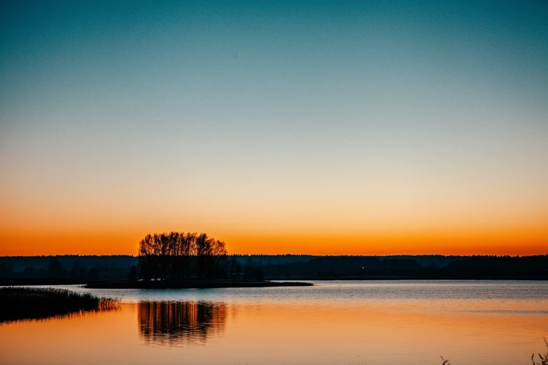 an orange and blue sunset over the ocean