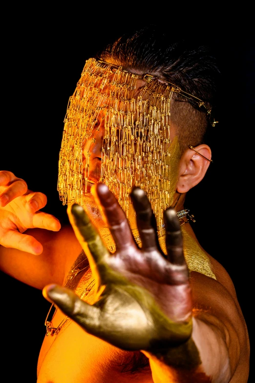 a man with fake gold hair covering his face