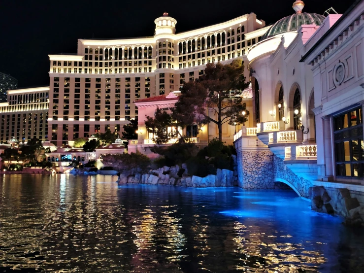 a large el by the water at night