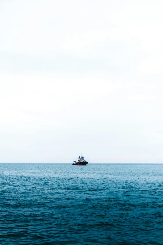 small boat floating in open water on calm day