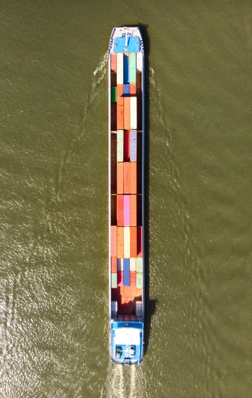 a large boat carrying lots of colorful containers