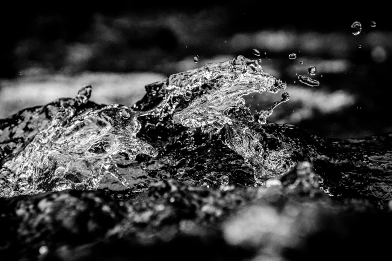 a rock with raindrops falling off it in the night