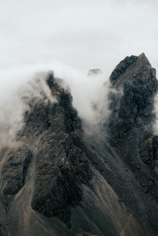 fog hangs over an area that looks like rocky mountains