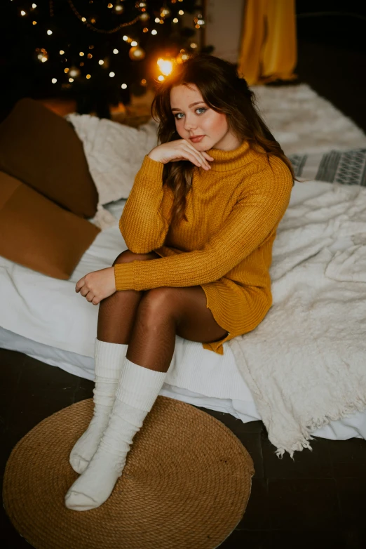 a girl is posing with her feet on the edge of a bed