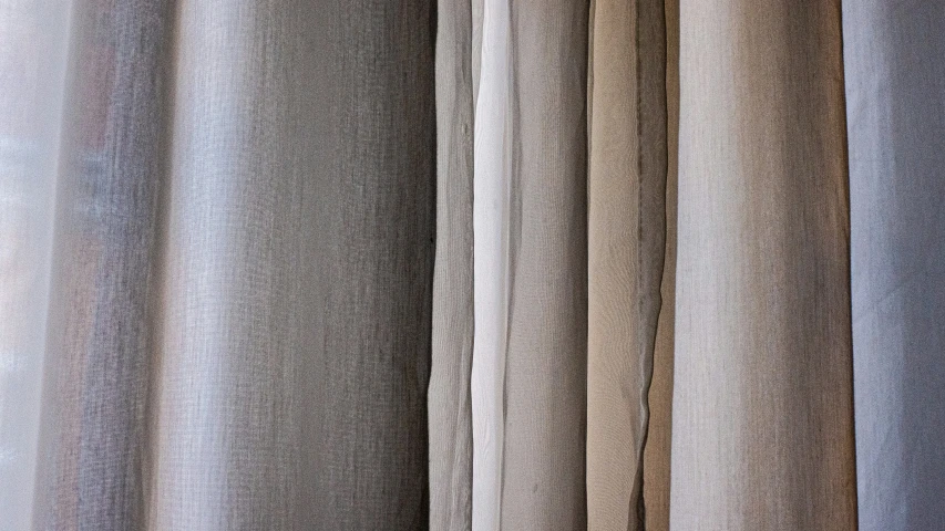 a group of sheer curtains hanging up against a window