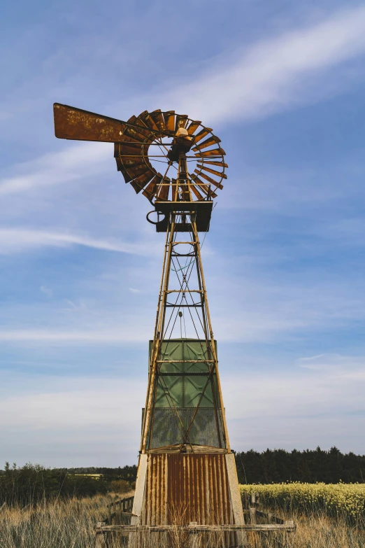 an old windmill that is standing out in the desert