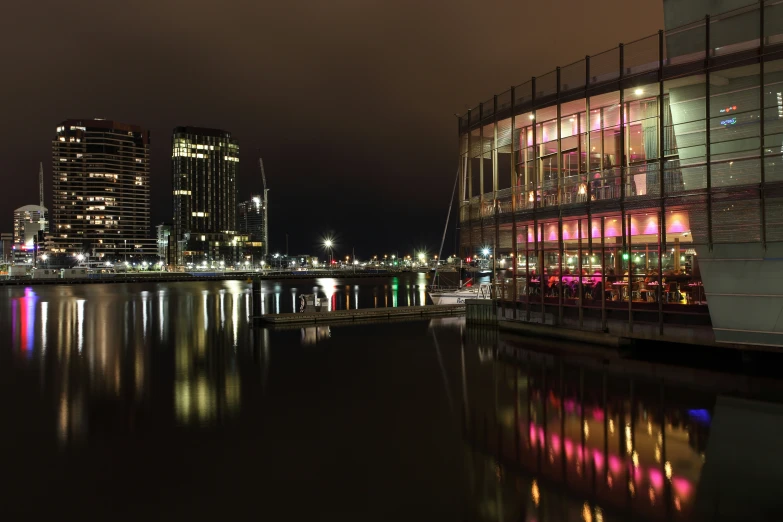 a night scene with a lake in the foreground