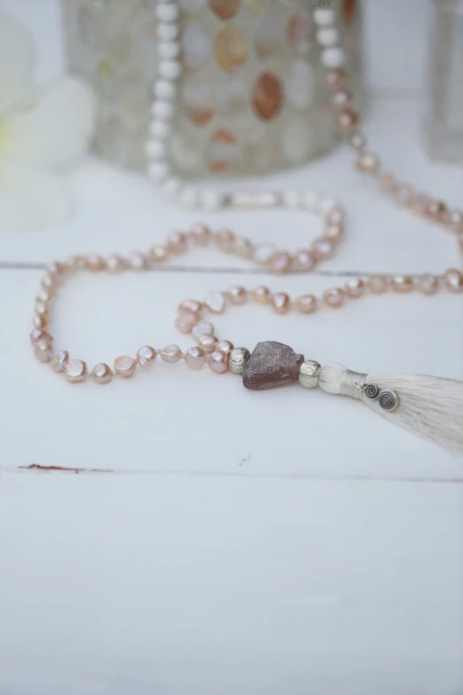 a tasselled necklace is placed on a table