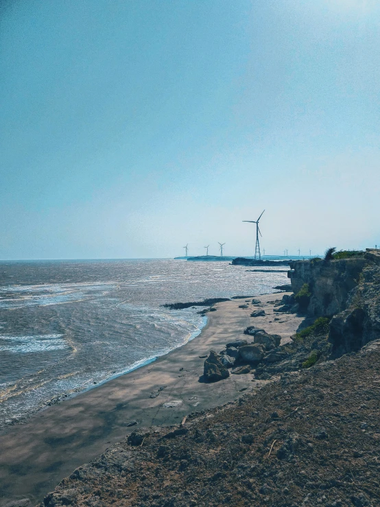 a view of an ocean along a hill near some water