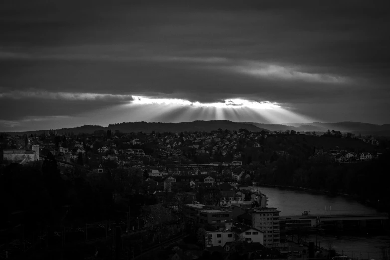 black and white pograph of light streaming from the clouds