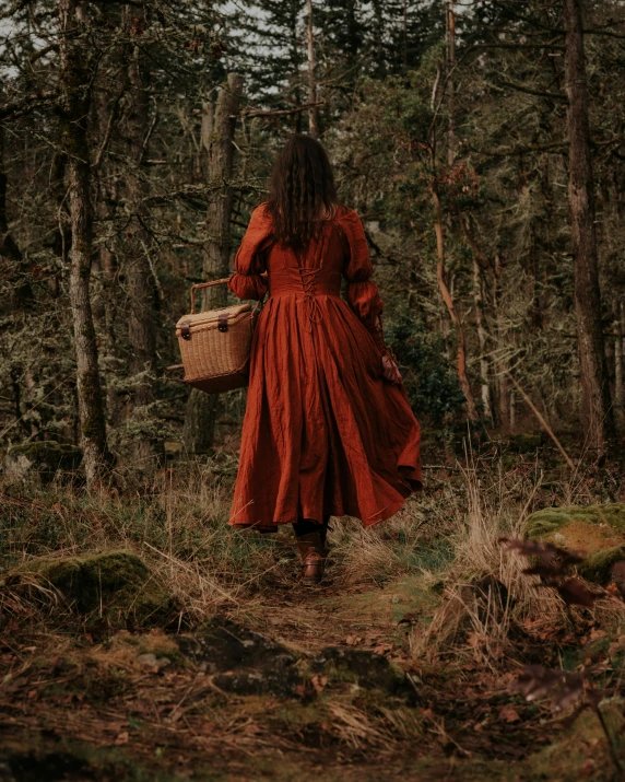 an image of a woman in red dress walking through the woods