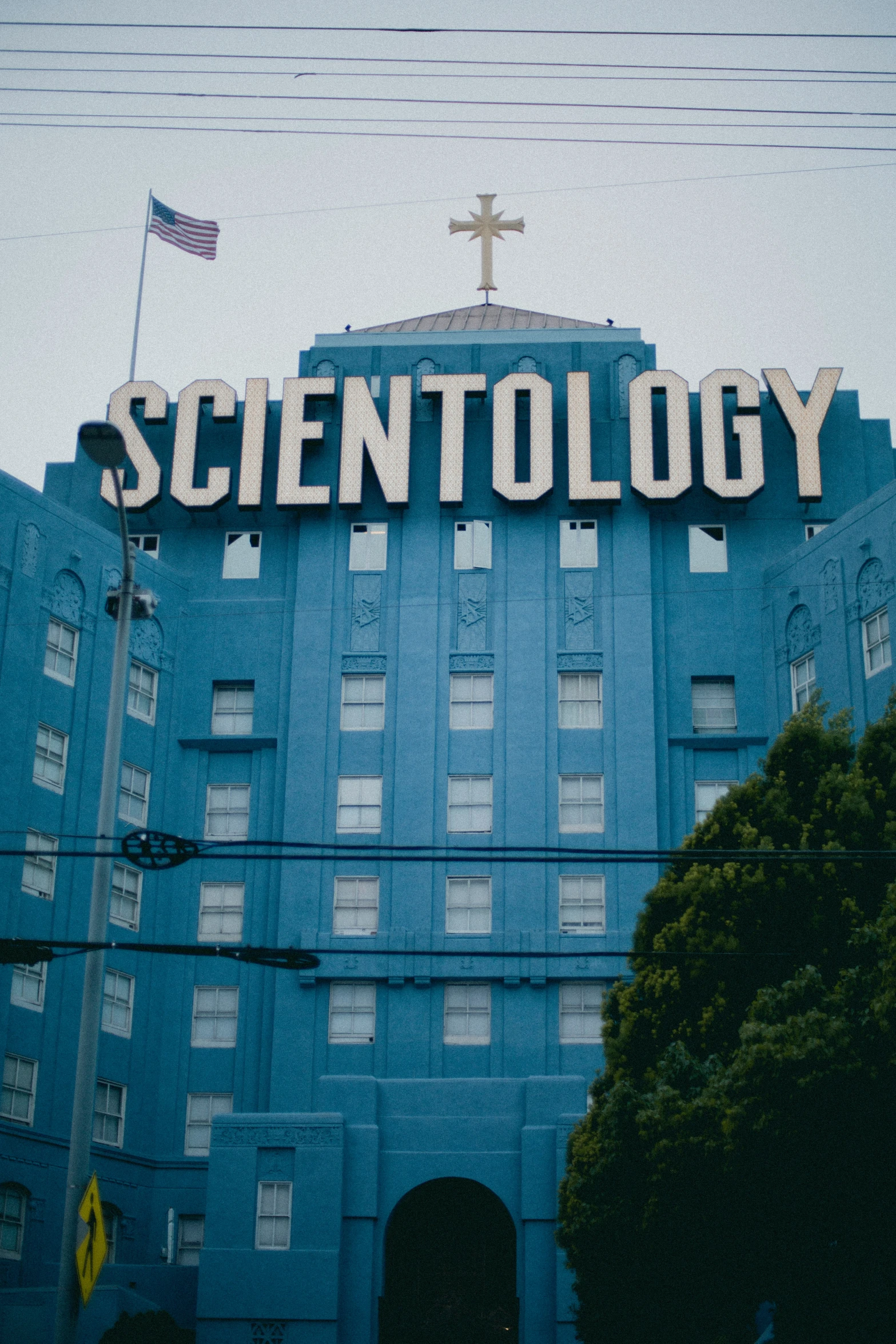 a large building has an scientology on top