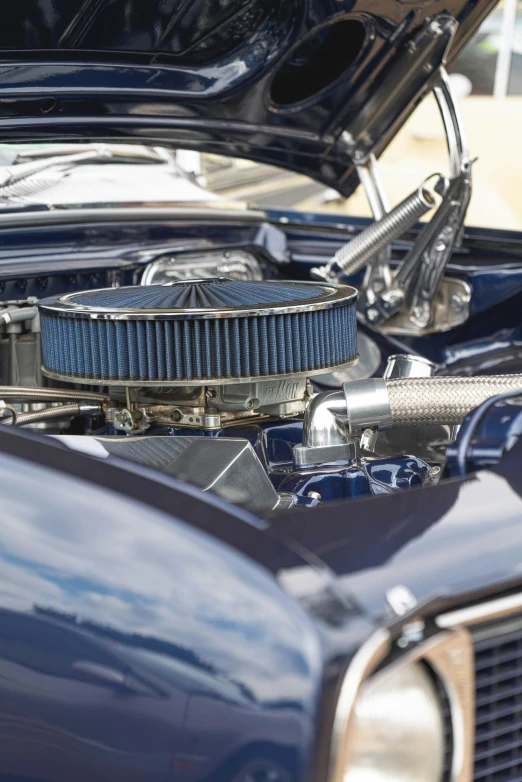 closeup of a blue classic car with engine