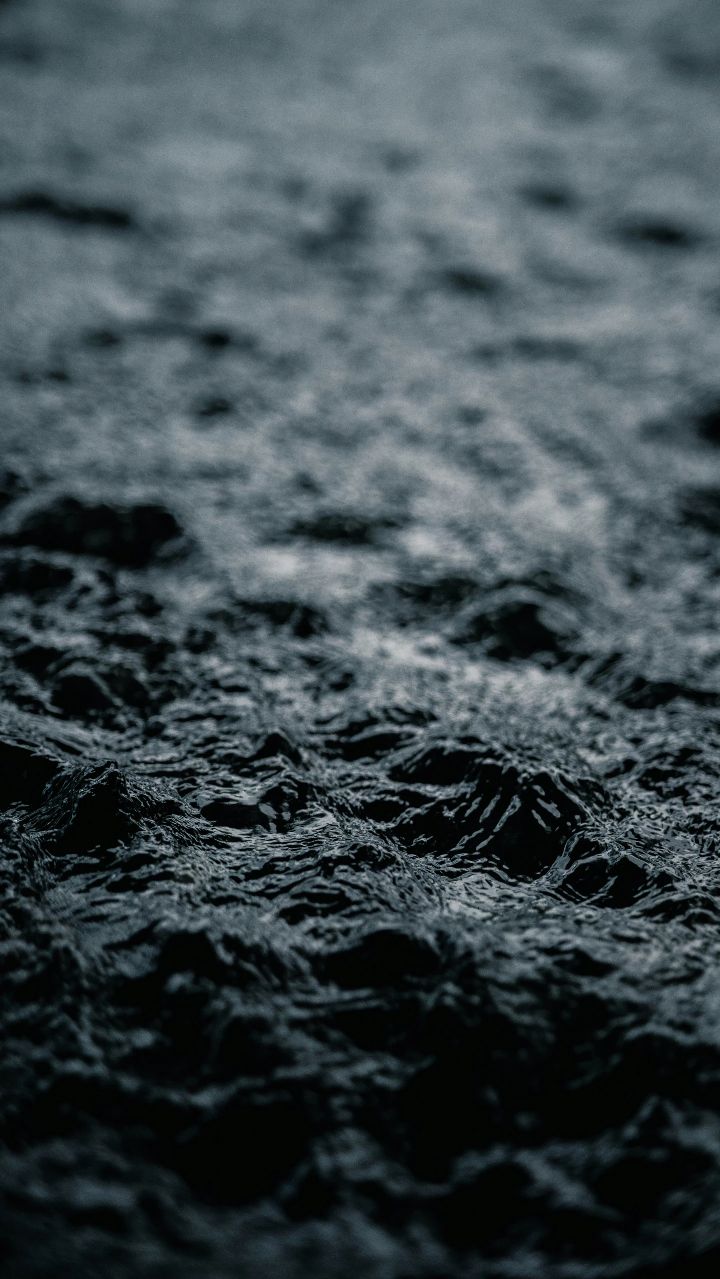 closeup of dark colored water with small waves