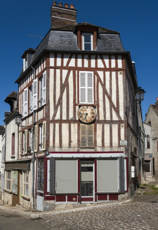 the corner of a building that has a clock on the front