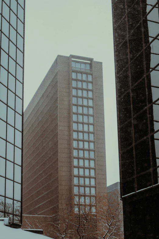 a couple of skyscrs sitting next to each other in the snow