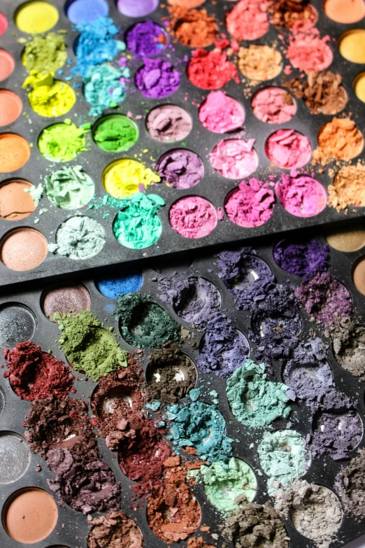 several color palettes with some of them covered in powder