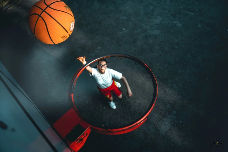 a man is in the middle of a hoop playing basketball