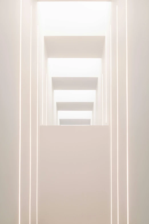 an array of lights in the middle of a white room