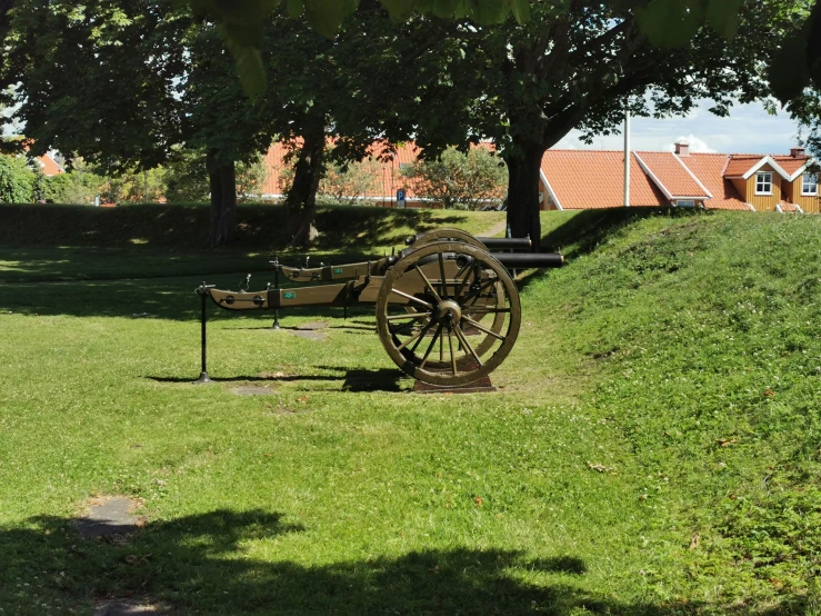 a large, wooden wagon and water pump in the park