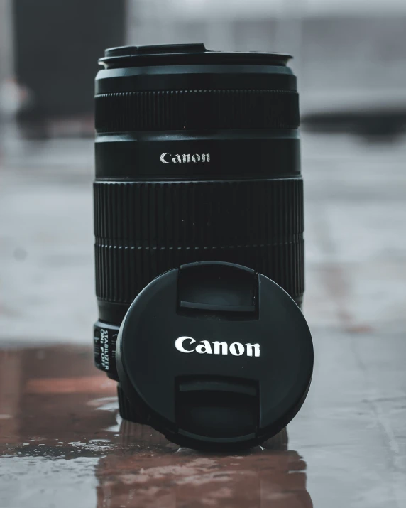 a very big camera lens sitting on the ground