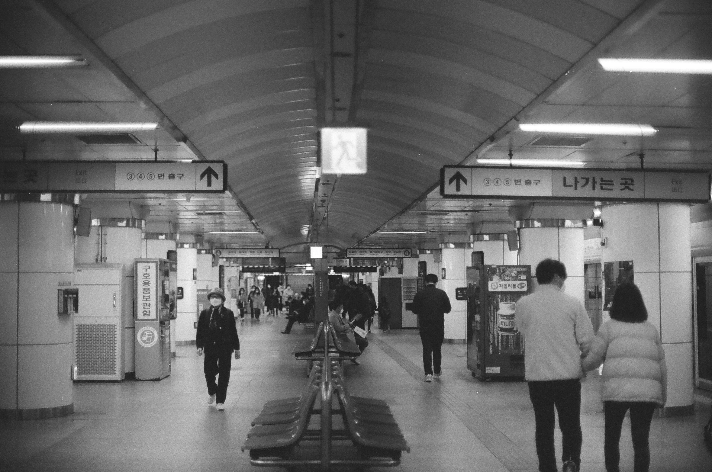 an underground station has people walking along it