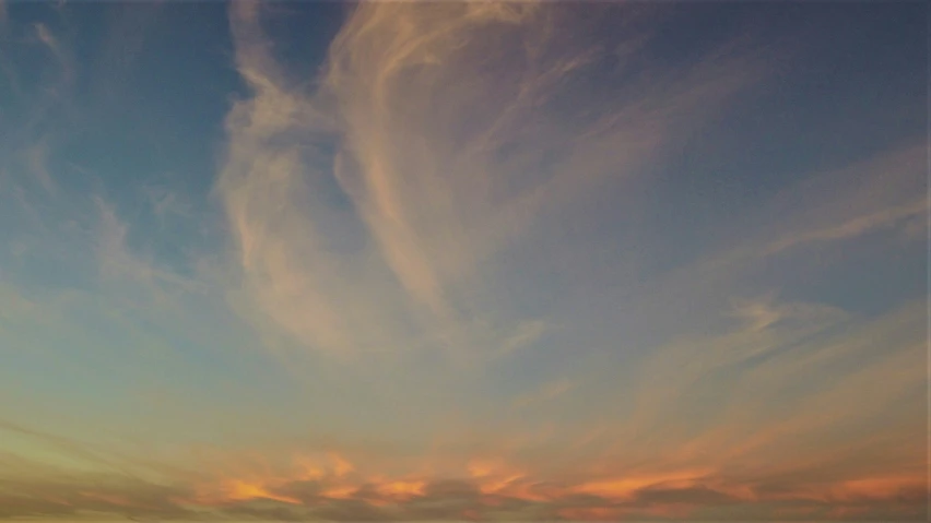 there is a bright blue sky and some clouds