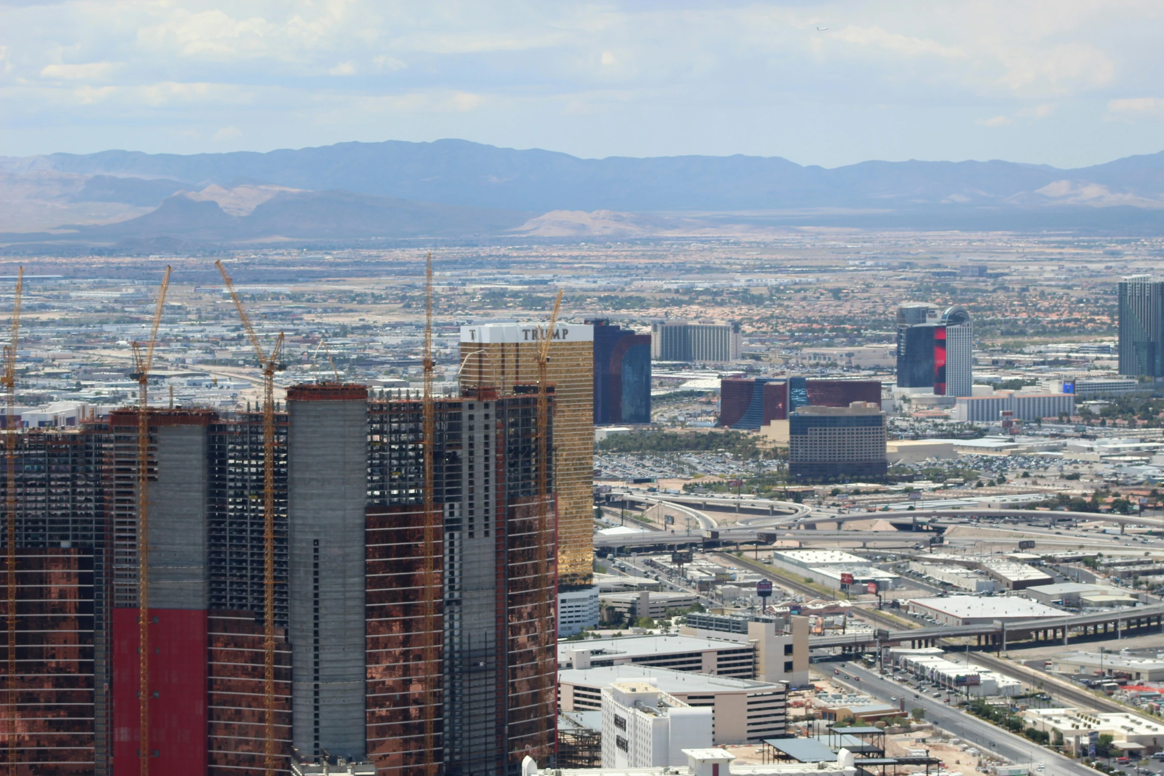 the city with tall buildings near some mountains