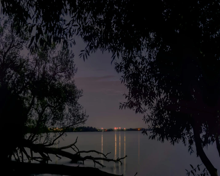 a night view with some water and lights on it