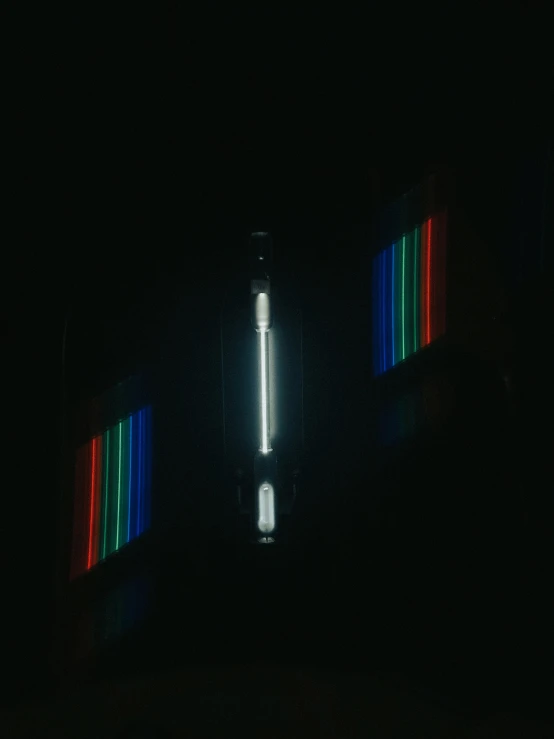 the side of a tall building lit up with different colored strips