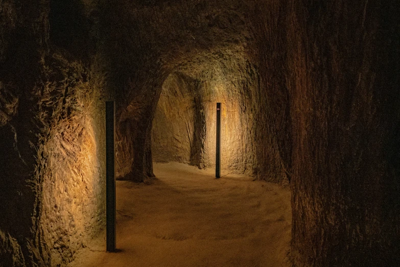 a narrow tunnel in an area with dark walls