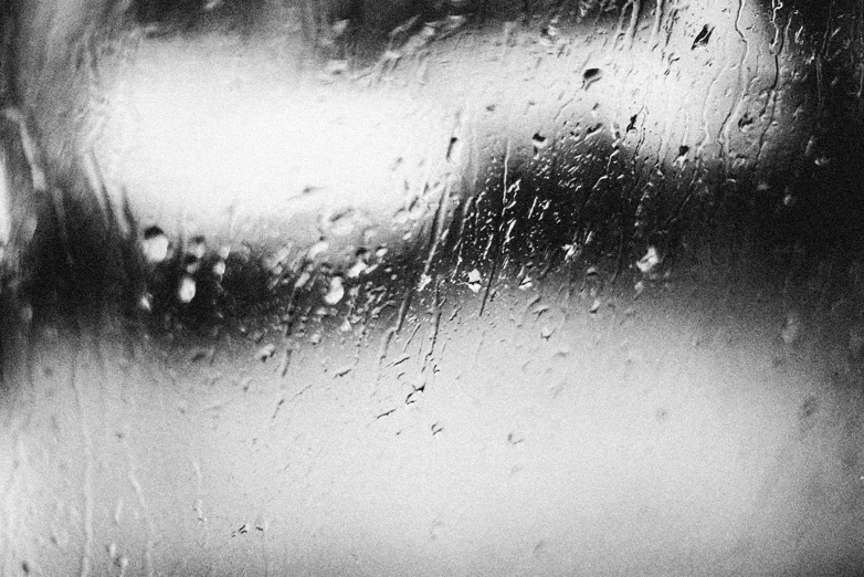 black and white pograph of rain on window