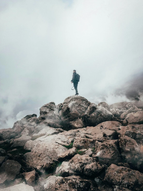 the man standing on top of a rocky cliff