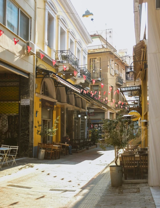 an alleyway with outdoor seating and shops