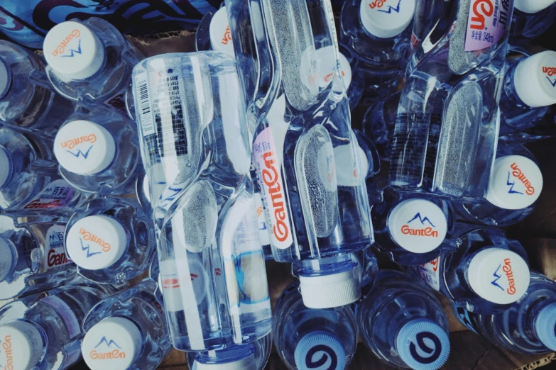 several water bottles with water lids in display