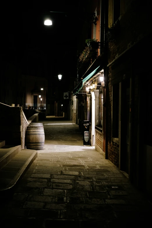 a long dimly lit alley way with a lamp on