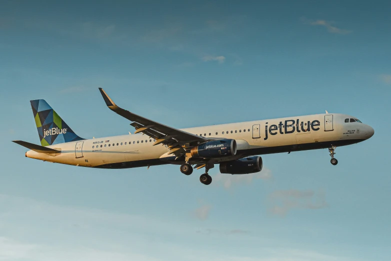 a jetblue airliner flying in the sky